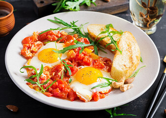 Late breakfast - fried eggs with vegetables. Shakshuka. Arabic cuisine. Kosher food.
