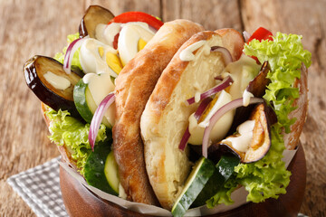 Sabich or sabih is an Israeli sandwich based on a traditional Iraqi Jewish dish close-up on the table. Horizontal