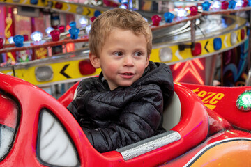 Obraz na płótnie Canvas portrait of little boy in a merry-go-round