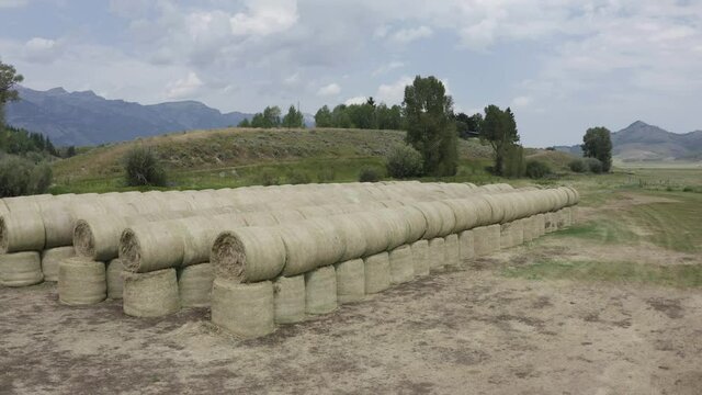Aerial View of Hay in Landscape of Grand Teton National Park Outside of Jackson Hole. Perfect Low Drone Shot Circling Revolving around the Neatly Stacked Hay, Americana, Rural Establishing shot.