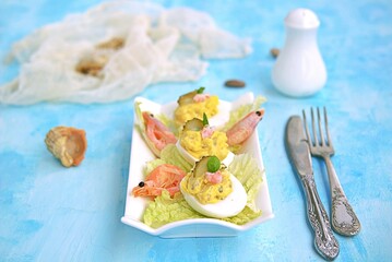 Cold appetizer, stuffed eggs with shrimps and pickled cucumber