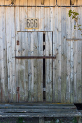 Ancient Abandoned Barn Door with number 666
