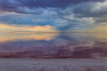 Dark storm clouds over a salt lake before a rain