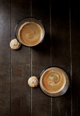 Two Glasses Of Coffee on dark wooden background. Top view. 