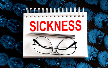 Text SICKNESS on a mri background. Nearby are various medicines. Medical concept.