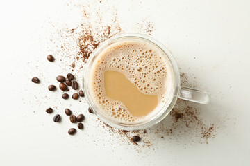 Cup of coffee and coffee beans on white background