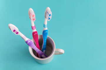 Three new toothbrushes on a blue background