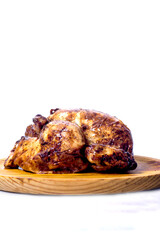Roast chicken on a wooden tray on white background