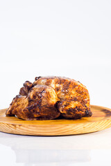 Roast chicken on a wooden tray on white background