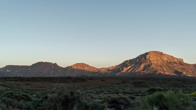 Time lapse of sunshine fading on mountainside of Canary Islands with clear sky