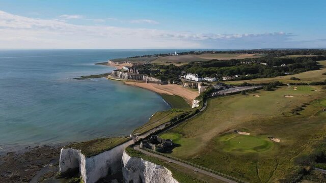 Drone aerial shot of Empty Kingsgate Beach and Castle on the cliffs above the Bay, on cloudy autumn morning.