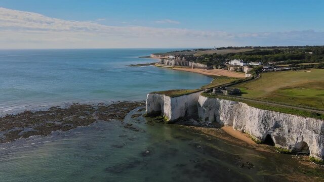 Drone aerial shot of Empty Kingsgate Beach and Castle on the cliffs above the Bay, on cloudy autumn morning.