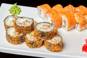 Warm roll with fried salmon, perch, cream cheese, cucumber and roll philadelphia. Close-up, selective focus