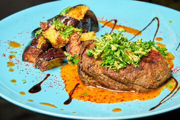 Veal fillet with baked eggplant. Close-up, selective focus