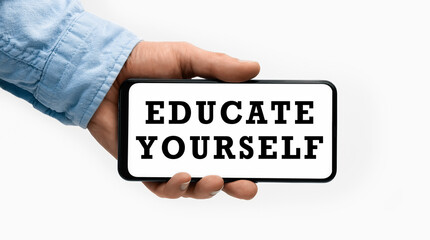 Closeup of a male hand holding Smartphone with text EDUCATE YOURSELF on display