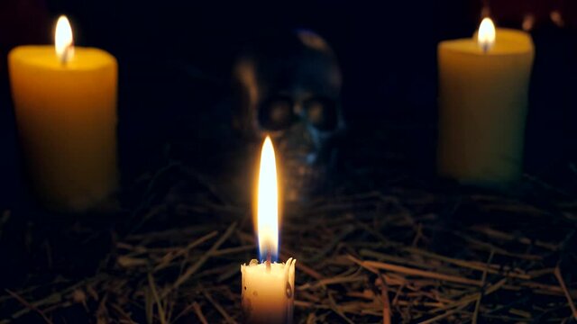 halloween concept. candles with skull on dark background. focus on candle