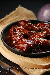barbecue chicken wings close up on wooden. buffalo chicken wings