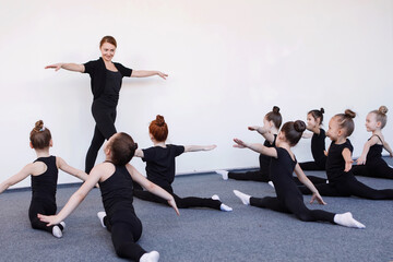 Girls dancer in black leotard in class.