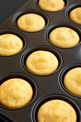 Homemade Cornbread Muffins on a black background, low angle view. Close-up.