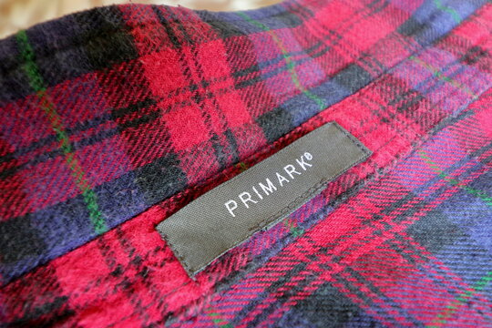 BRAUNSCHWEIG, LOWER SAXONY, GERMANY - MARCH 4, 2019: Fabric Primark tag. Textile label stitched on unisex shirt in Lumberjack design. Primark, also named Penneys, is an Irish fast fashion retailer. 