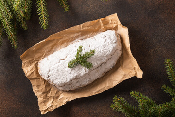 Christmas stollen - traditional German bread on brown. Holiday pastry dessert. View from above.
