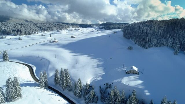 Drone winter mountain view of a beautiful snowy and sunny valley