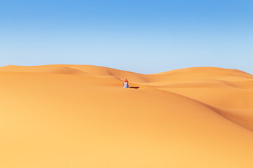 Beautiful girl in the Sahara desert.