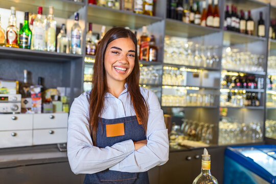 Waitress wearing apron smilling looking at camera. Happy businesswoman. Small business owner of girl entrepreneur. Cafe employee posing in restaurant coffee shop