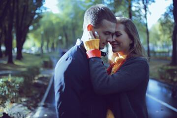 Obraz premium autumn landscape with people in the park / gerfrend and boyfriend hug in autumn park, fall view person