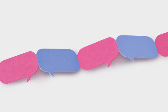 Pink and blue speech bubbles linked together in a chain - Concept of communication between men and women (gender communication)