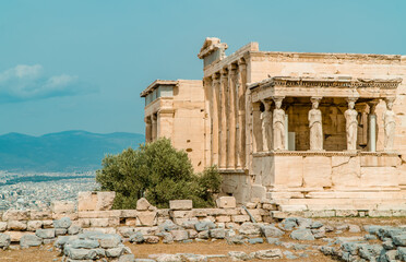 Caryatides, Erechtheion Temple at the Acropolis of Athens with a city view of Athens, Greece in the...