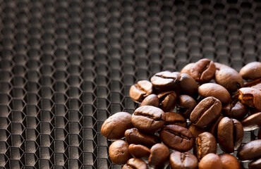 Broken coffee beans, roasted coffee beans background with smoke, (selective focus coffee beans) roaster rack base background