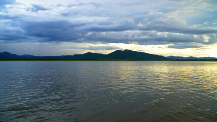 sunset in the evening with a vast reservoir and mountains