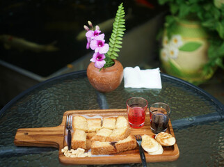 A over milk sweet water on a bread down on in the wood plate of the toasts set on the table in cafe.