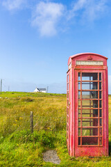 Red telephone box and crofters houses at North Uist, Outer Hebrides, Scotland