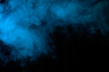 Fototapeta na wymiar Blue smoke on black background