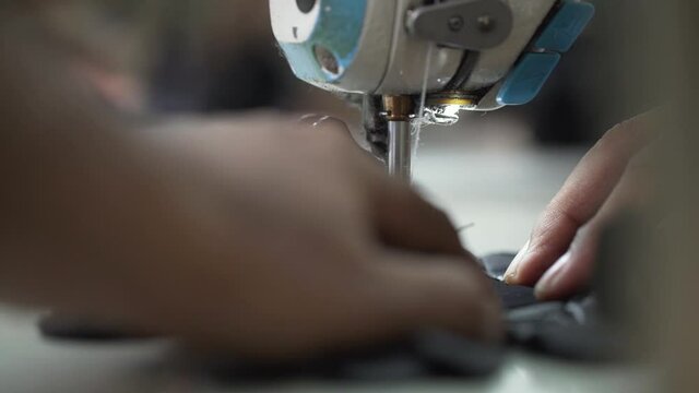 Worker Sewing And Stitching Leather Fashion Gloves In Manufacturing Factory