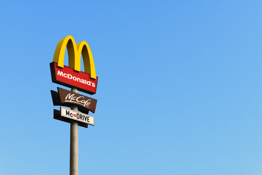 McDonald's logo against a blue sky in ELLWANGEN, GERMANY - SEPTEMBER 01, 2019.
