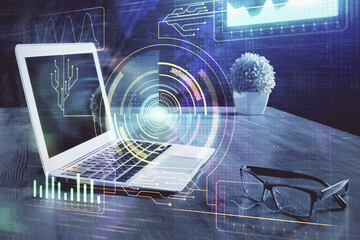 Double exposure of laptop computer and technology theme hologram. Concept of freelance work.