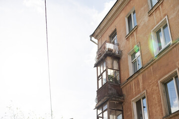 Fototapeta na wymiar old balcony of old house and birch grow on the balcony
