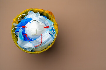 Used infectious masks and medical glove in the trash bin