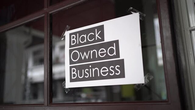 Black owned business sign attached on the window