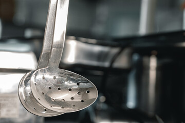 New metal kitchenware in a row close up