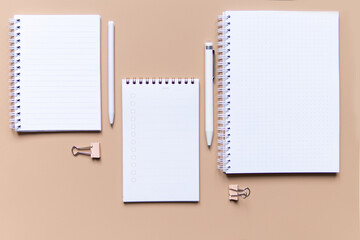 business composition with notebooks and pens on a brown background with a place for writing.