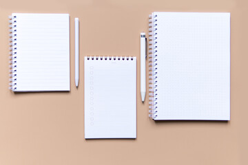 business composition with notebooks and pens on a brown background with a place for writing.