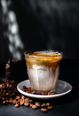 Dirty Coffee or milk coffee latte on a black table.