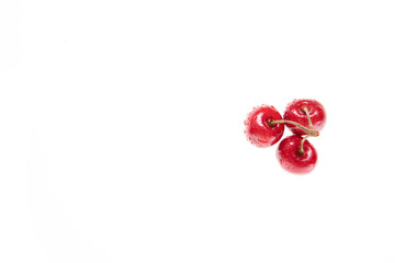 red raw fresh cherries on white background, close view 