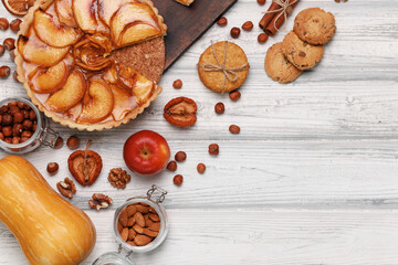 Top view of an apple pie on white wooden surface