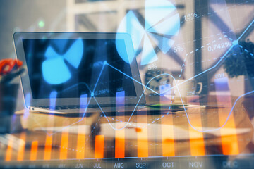 Forex market chart hologram and personal computer background. Double exposure. Concept of investment.