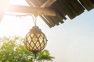 Lantern Hanging on the Porch of a Rural House